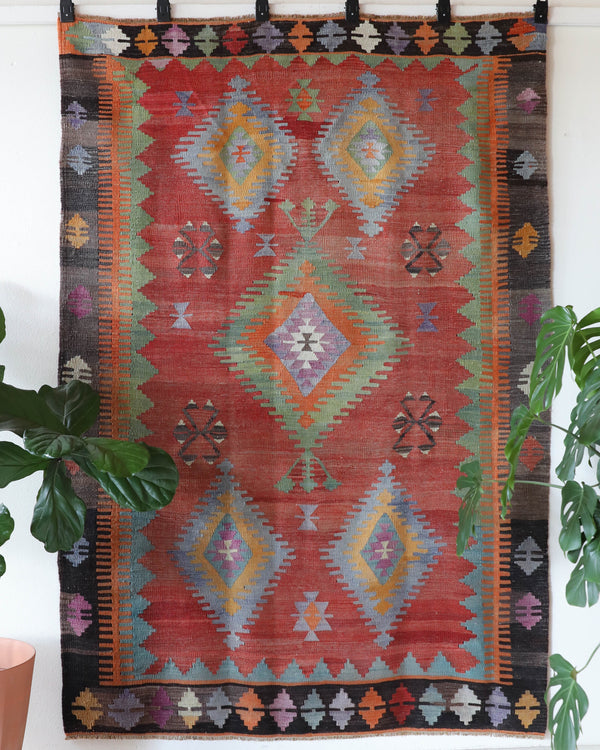 Vintage kilim rug in living room setting, old rug, antique rug, pastel colors, faded colors, Turkish rug, vintage rug, soft rug, Portland, Oregon, rug store, rug shop, local shop, earthy tones, earthy colors, warm colors