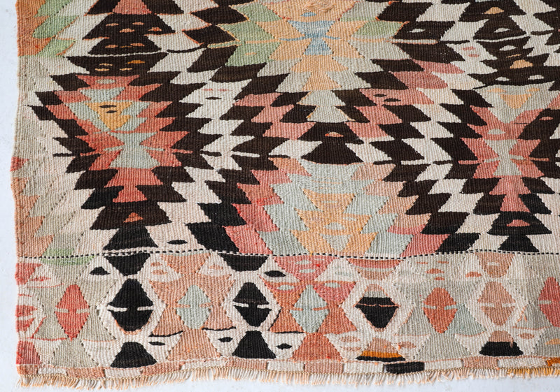 Vintage kilim rug in living room setting, old rug, antique rug, pastel colors, faded colors, Turkish rug, vintage rug, soft rug, Portland, Oregon, rug store, rug shop, local shop, earthy tones, earthy colors, warm colors