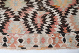 Vintage kilim rug in living room setting, old rug, antique rug, pastel colors, faded colors, Turkish rug, vintage rug, soft rug, Portland, Oregon, rug store, rug shop, local shop, earthy tones, earthy colors, warm colors