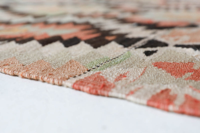 Vintage kilim rug in living room setting, old rug, antique rug, pastel colors, faded colors, Turkish rug, vintage rug, soft rug, Portland, Oregon, rug store, rug shop, local shop, earthy tones, earthy colors, warm colors