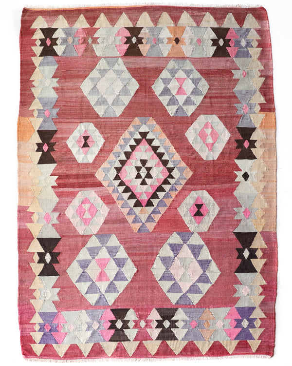 Vintage kilim rug in living room setting, old rug, antique rug, pastel colors, faded colors, Turkish rug, vintage rug, soft rug, Portland, Oregon, rug store, rug shop, local shop, earthy tones, earthy colors, warm colors