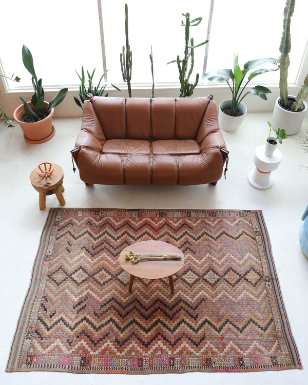 Vintage kilim rug in living room setting, old rug, antique rug, pastel colors, faded colors, Turkish rug, vintage rug, soft rug, Portland, Oregon, rug store, rug shop, local shop, earthy tones, earthy colors, warm colors