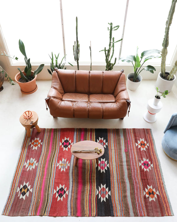 Vintage kilim rug in room decor setting, old rug, antique rug, pastel colors, faded colors, Turkish rug, vintage rug, soft rug, Portland, Oregon, rug store, rug shop, local shop, bold colors, bright colors, faded colors