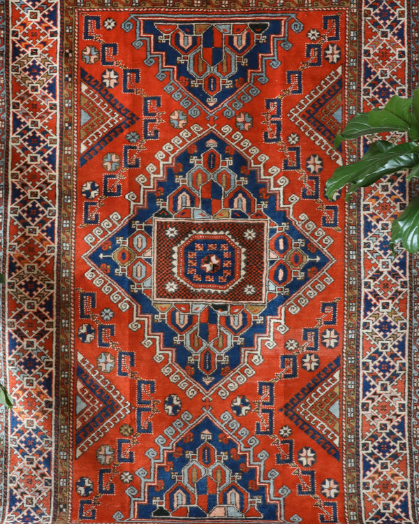 Vintage Turkish rug in a living room setting, pile rug, Turkish rug, vintage rug, portland, rug shop, bright colors, wild shaman, soft rug, bold color, Portland, Oregon, rug store, rug shop, local shop, antique rug