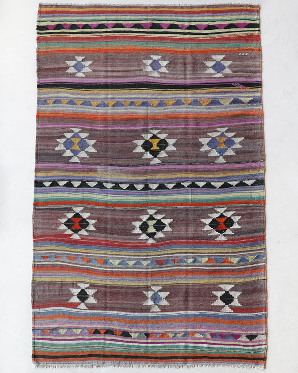 Vintage kilim rug in room decor setting, old rug, antique rug, pastel colors, faded colors, Turkish rug, vintage rug, soft rug, Portland, Oregon, rug store, rug shop, local shop, bold colors, bright colors, faded colors