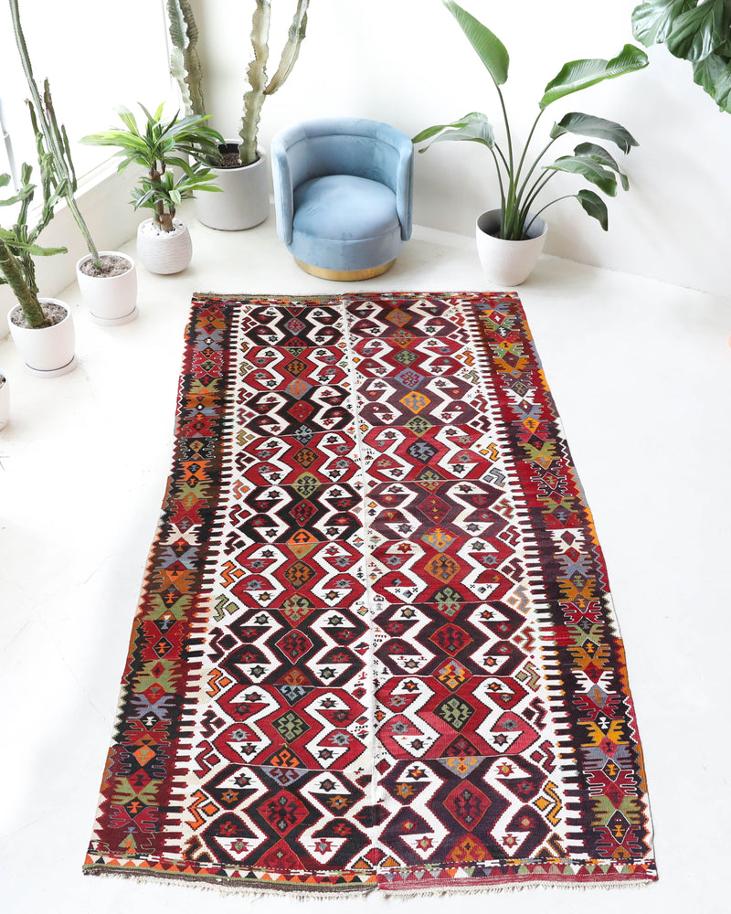 Vintage kilim rug in room decor setting, old rug, antique rug, pastel colors, faded colors, Turkish rug, vintage rug, soft rug, Portland, Oregon, rug store, rug shop, local shop,  antique kilim rug, bold colors, bright colors