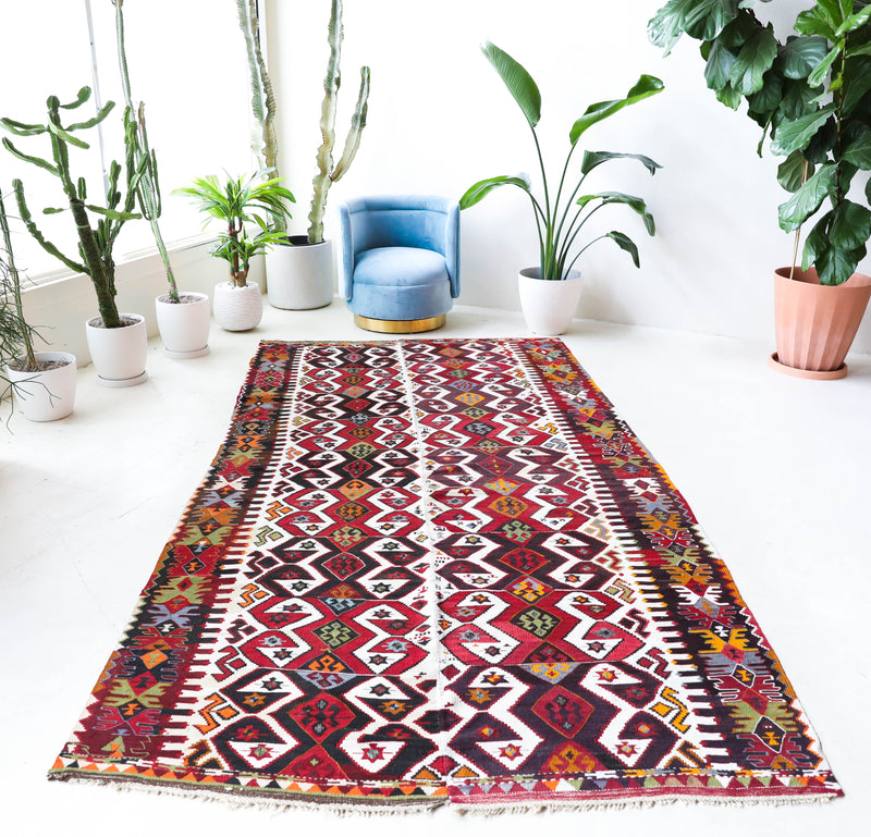 Vintage kilim rug in room decor setting, old rug, antique rug, pastel colors, faded colors, Turkish rug, vintage rug, soft rug, Portland, Oregon, rug store, rug shop, local shop,  antique kilim rug, bold colors, bright colors