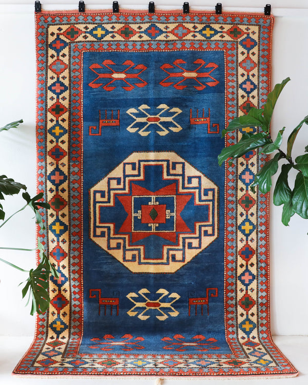 Vintage Turkish rug in a living room setting, pile rug, Turkish rug, vintage rug, portland, rug shop, bright colors, wild shaman, soft rug, bold color, Portland, Oregon, rug store, rug shop, local shop, antique rug