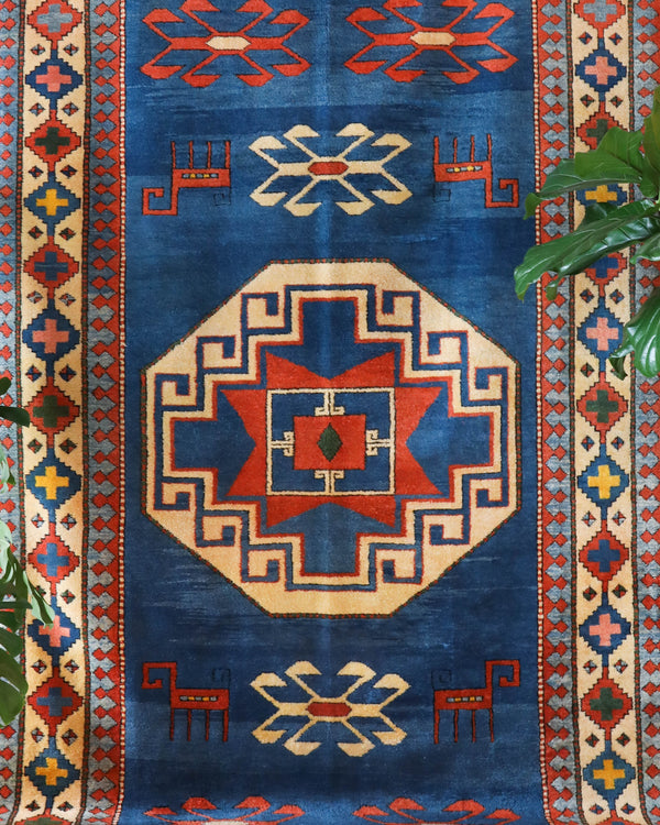 Vintage Turkish rug in a living room setting, pile rug, Turkish rug, vintage rug, portland, rug shop, bright colors, wild shaman, soft rug, bold color, Portland, Oregon, rug store, rug shop, local shop, antique rug