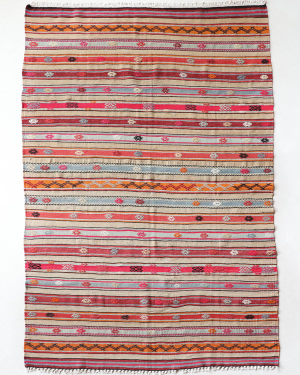 Vintage kilim rug in living room setting, old rug, antique rug, pastel colors, faded colors, Turkish rug, vintage rug, soft rug, Portland, Oregon, rug store, rug shop, local shop, earthy tones, earthy colors, warm colors