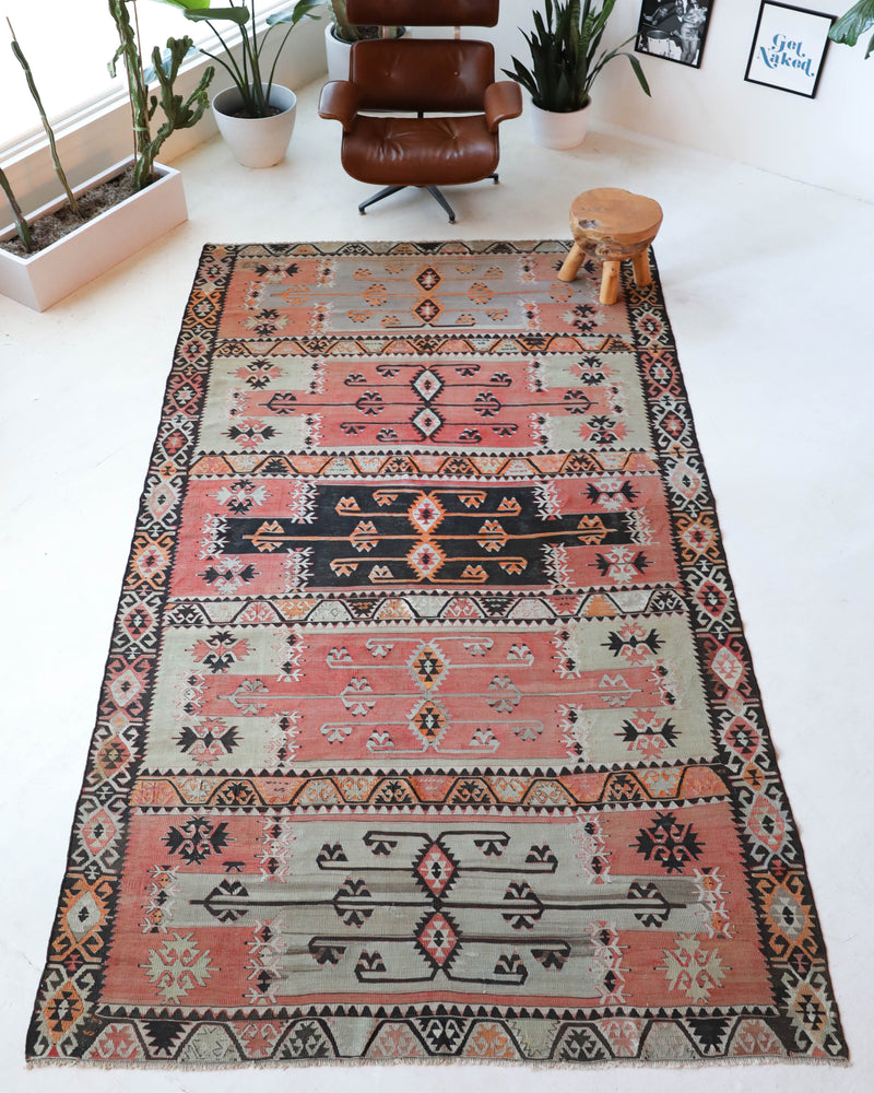  Vintage kilim rug in living room setting, old rug, antique rug, pastel colors, faded colors, Turkish rug, vintage rug, soft rug, Portland, Oregon, rug store, rug shop, local shop, earthy tones, earthy colors, warm colors