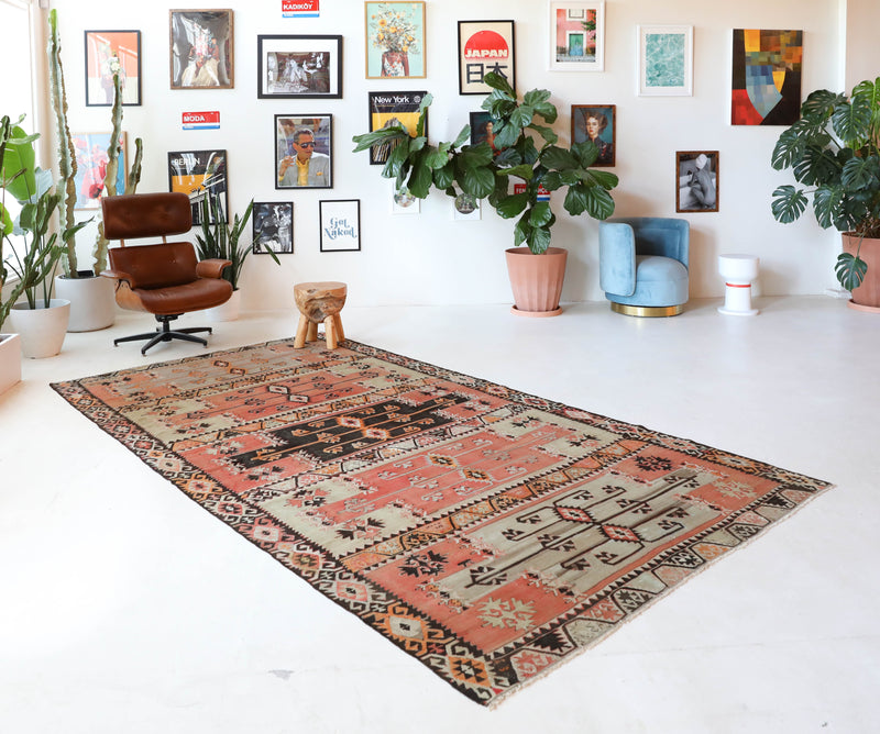  Vintage kilim rug in living room setting, old rug, antique rug, pastel colors, faded colors, Turkish rug, vintage rug, soft rug, Portland, Oregon, rug store, rug shop, local shop, earthy tones, earthy colors, warm colors