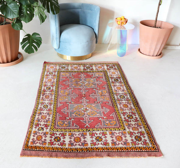  Small Turkish rug in a living room setting, pile rug, Turkish rug, vintage rug, portland, rug shop, bright colors, wild shaman, area rug, red rug, mini rug, bold color, Portland, Oregon, rug store, rug shop, local shop, flat weave, kilim rug