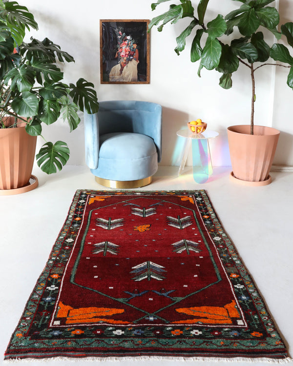 Small Turkish rug in a living room setting, pile rug, Turkish rug, vintage rug, portland, rug shop, bright colors, wild shaman, area rug, red rug, mini rug, bold color, Portland, Oregon, rug store, rug shop, local shop, flat weave, kilim rug