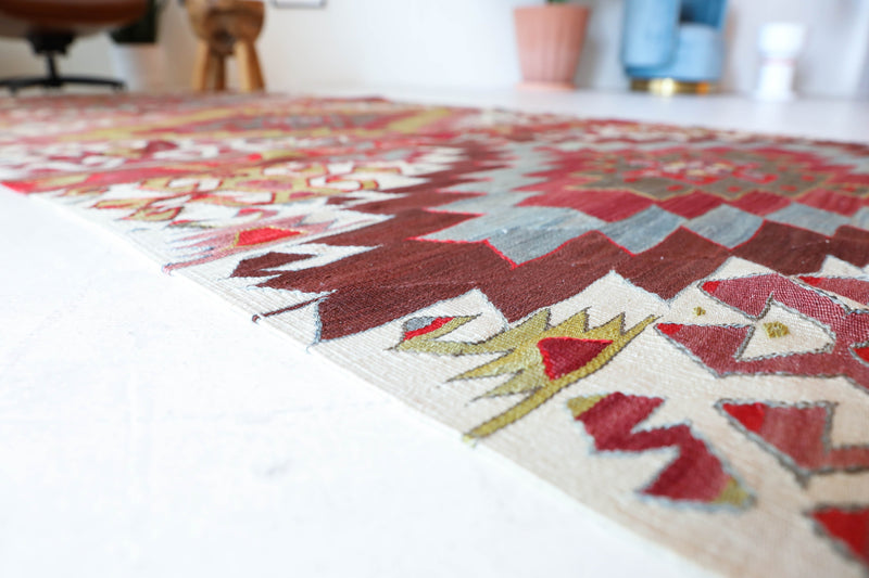 Vintage kilim rug in living room setting, old rug, antique rug, pastel colors, faded colors, Turkish rug, vintage rug, soft rug, Portland, Oregon, rug store, rug shop, local shop, earthy tones, earthy colors, warm colors