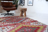 Vintage kilim rug in living room setting, old rug, antique rug, pastel colors, faded colors, Turkish rug, vintage rug, soft rug, Portland, Oregon, rug store, rug shop, local shop, earthy tones, earthy colors, warm colors