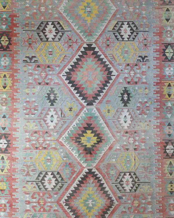 Vintage kilim rug in living room setting, old rug, antique rug, pastel colors, faded colors, Turkish rug, vintage rug, soft rug, Portland, Oregon, rug store, rug shop, local shop, earthy tones, earthy colors, warm colors