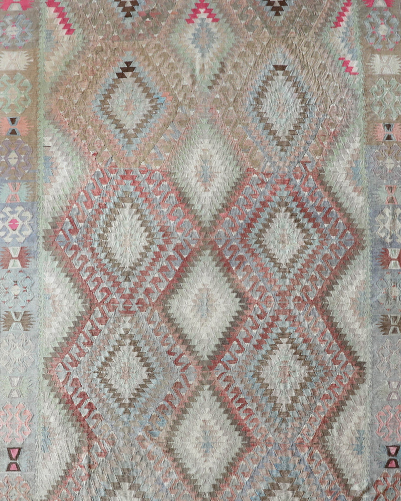 Vintage kilim rug in living room setting, old rug, antique rug, pastel colors, faded colors, Turkish rug, vintage rug, soft rug, Portland, Oregon, rug store, rug shop, local shop, earthy tones, earthy colors, warm colors