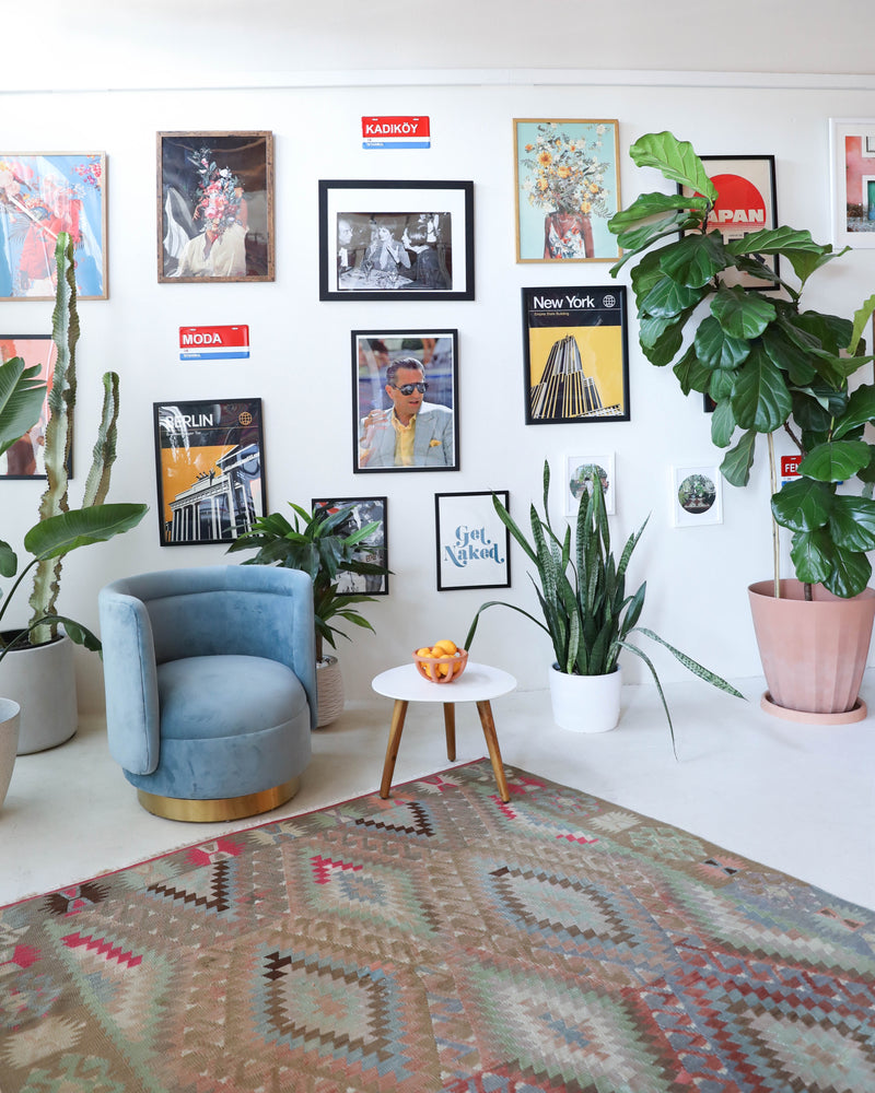 Vintage kilim rug in living room setting, old rug, antique rug, pastel colors, faded colors, Turkish rug, vintage rug, soft rug, Portland, Oregon, rug store, rug shop, local shop, earthy tones, earthy colors, warm colors