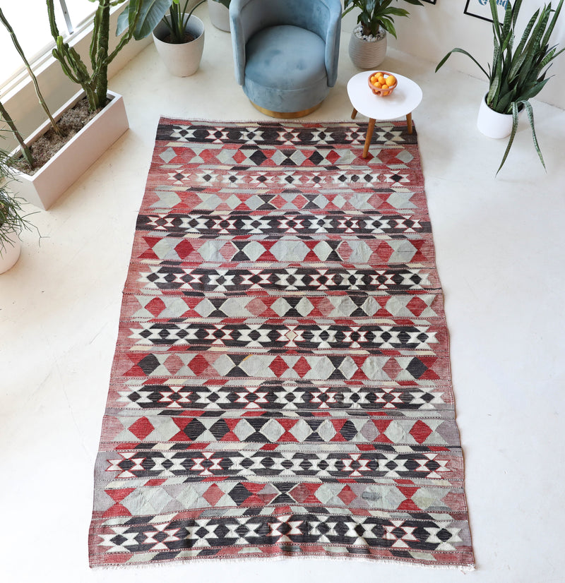 Vintage kilim rug in living room setting, old rug, antique rug, pastel colors, faded colors, Turkish rug, vintage rug, soft rug, Portland, Oregon, rug store, rug shop, local shop, earthy tones, earthy colors, warm colors