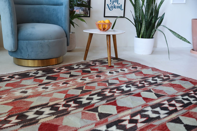 Vintage kilim rug in living room setting, old rug, antique rug, pastel colors, faded colors, Turkish rug, vintage rug, soft rug, Portland, Oregon, rug store, rug shop, local shop, earthy tones, earthy colors, warm colors