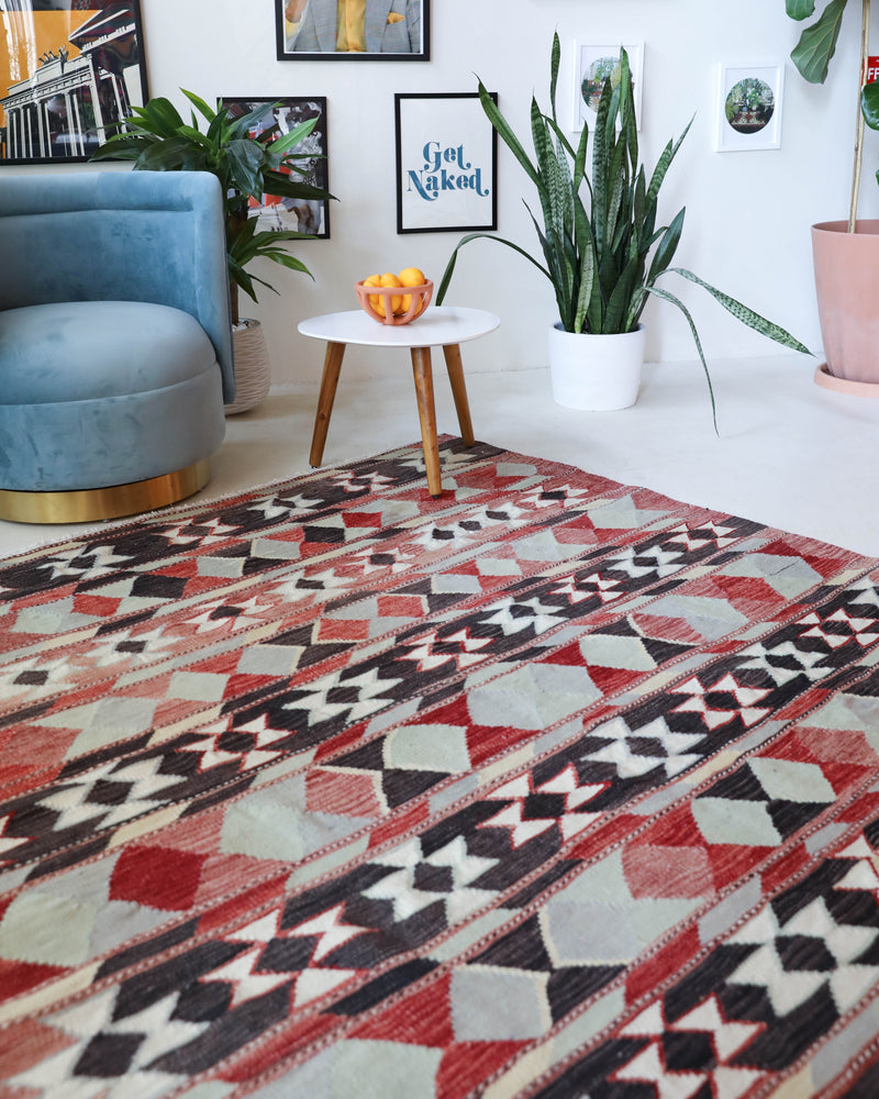 Vintage kilim rug in living room setting, old rug, antique rug, pastel colors, faded colors, Turkish rug, vintage rug, soft rug, Portland, Oregon, rug store, rug shop, local shop, earthy tones, earthy colors, warm colors