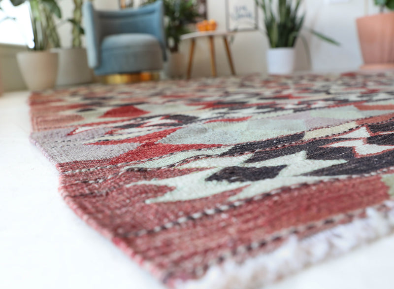 Vintage kilim rug in living room setting, old rug, antique rug, pastel colors, faded colors, Turkish rug, vintage rug, soft rug, Portland, Oregon, rug store, rug shop, local shop, earthy tones, earthy colors, warm colors