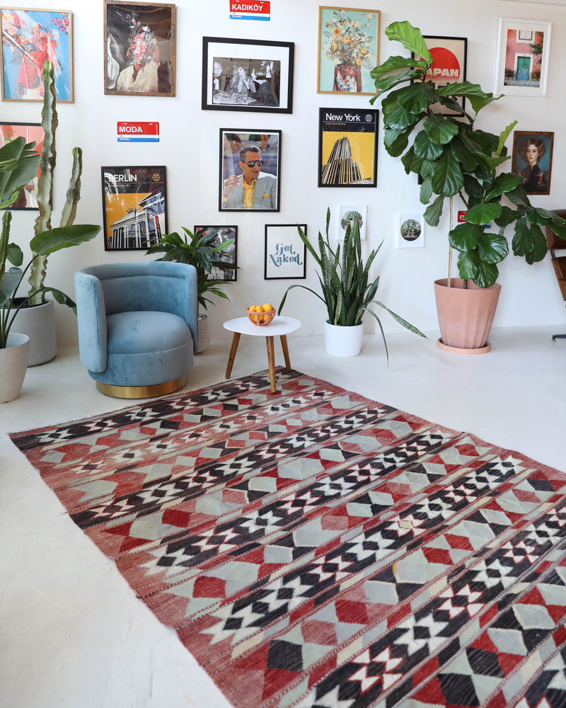 Vintage kilim rug in living room setting, old rug, antique rug, pastel colors, faded colors, Turkish rug, vintage rug, soft rug, Portland, Oregon, rug store, rug shop, local shop, earthy tones, earthy colors, warm colors