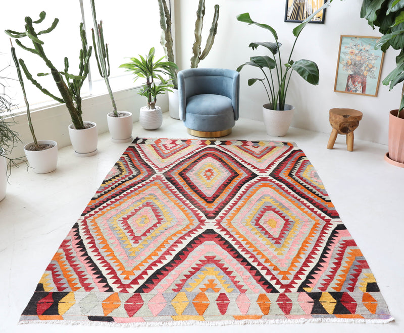 Vintage kilim rug in room decor setting, old rug, antique rug, pastel colors, faded colors, Turkish rug, vintage rug, soft rug, Portland, Oregon, rug store, rug shop, local shop,  antique kilim rug, bold colors, bright colors, faded colors
