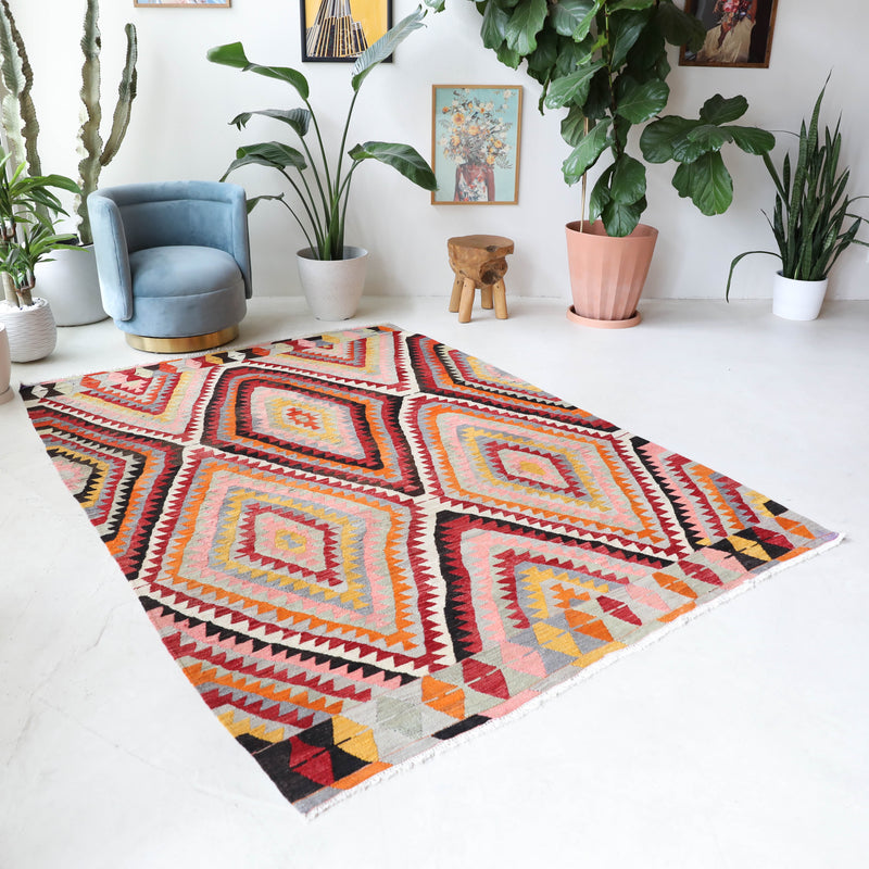Vintage kilim rug in room decor setting, old rug, antique rug, pastel colors, faded colors, Turkish rug, vintage rug, soft rug, Portland, Oregon, rug store, rug shop, local shop,  antique kilim rug, bold colors, bright colors, faded colors