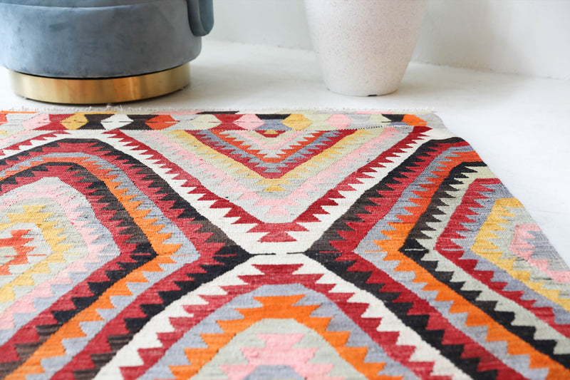 Vintage kilim rug in room decor setting, old rug, antique rug, pastel colors, faded colors, Turkish rug, vintage rug, soft rug, Portland, Oregon, rug store, rug shop, local shop,  antique kilim rug, bold colors, bright colors, faded colors