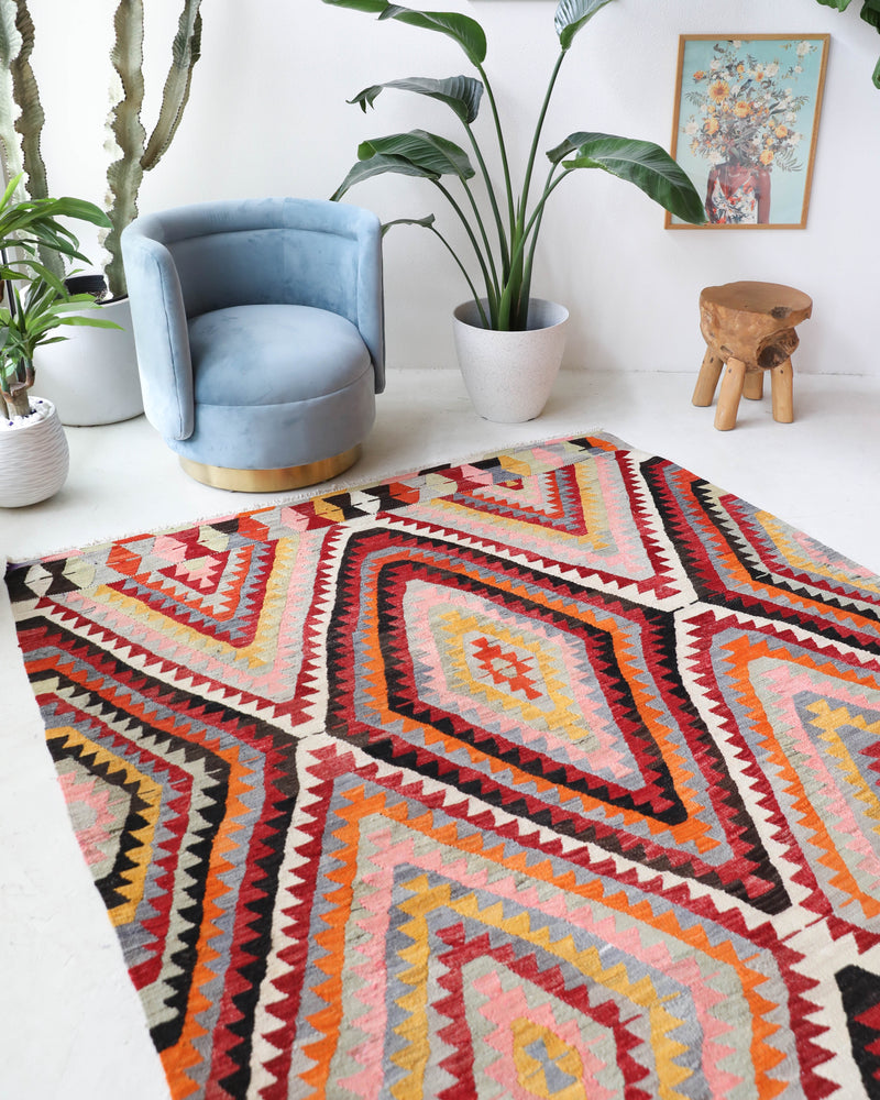Vintage kilim rug in room decor setting, old rug, antique rug, pastel colors, faded colors, Turkish rug, vintage rug, soft rug, Portland, Oregon, rug store, rug shop, local shop,  antique kilim rug, bold colors, bright colors, faded colors