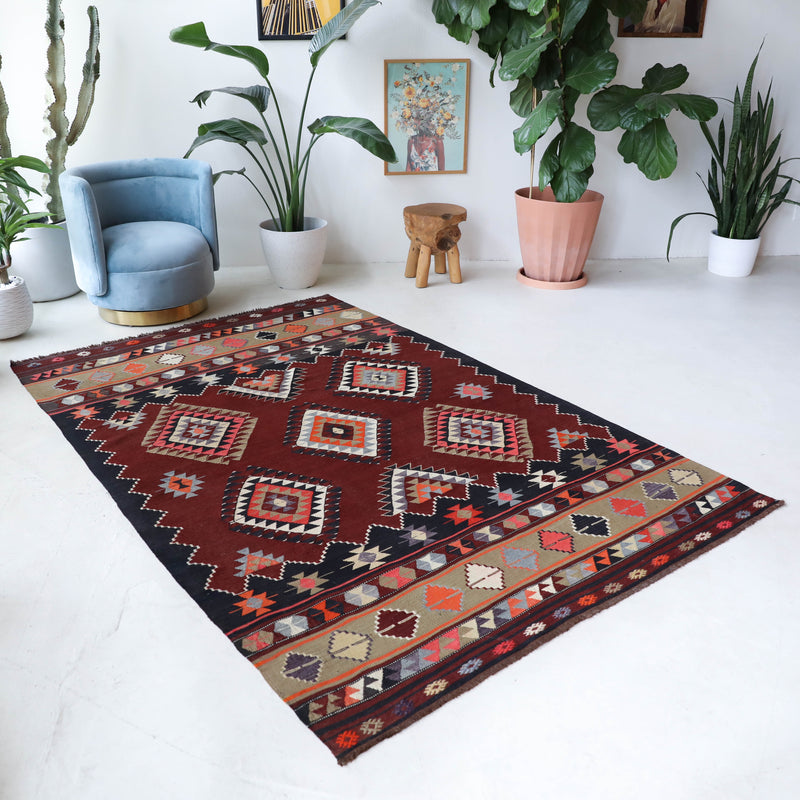 Vintage kilim rug in living room setting, bright colors, wild shaman, soft rug, bold color, Portland, Oregon, rug store, rug shop, local shop, vintage rug, modern kilim, warm colors, antique kilim rug