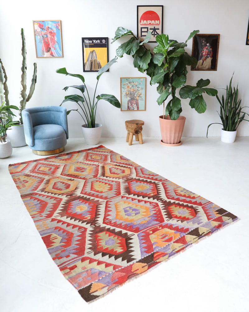 Vintage kilim rug in room decor setting, old rug, antique rug, pastel colors, faded colors, Turkish rug, vintage rug, soft rug, Portland, Oregon, rug store, rug shop, local shop,  antique kilim rug, bold colors, bright colors, faded colors