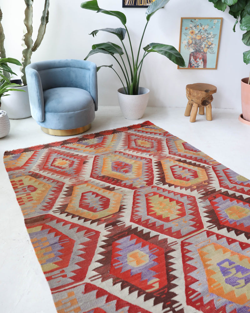 Vintage kilim rug in room decor setting, old rug, antique rug, pastel colors, faded colors, Turkish rug, vintage rug, soft rug, Portland, Oregon, rug store, rug shop, local shop,  antique kilim rug, bold colors, bright colors, faded colors