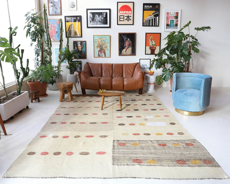 Vintage kilim rug in living room setting, old rug, antique rug, pastel colors, faded colors, Turkish rug, vintage rug, soft rug, Portland, Oregon, rug store, rug shop, local shop, earthy tones, earthy colors, warm colors