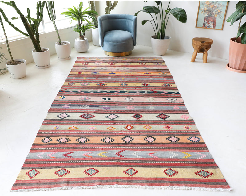 Vintage kilim rug in room decor setting, old rug, antique rug, pastel colors, faded colors, Turkish rug, vintage rug, soft rug, Portland, Oregon, rug store, rug shop, local shop,  antique kilim rug, bold colors, bright colors, faded colors