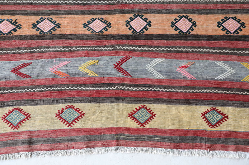 Vintage kilim rug in room decor setting, old rug, antique rug, pastel colors, faded colors, Turkish rug, vintage rug, soft rug, Portland, Oregon, rug store, rug shop, local shop,  antique kilim rug, bold colors, bright colors, faded colors