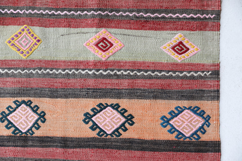 Vintage kilim rug in room decor setting, old rug, antique rug, pastel colors, faded colors, Turkish rug, vintage rug, soft rug, Portland, Oregon, rug store, rug shop, local shop,  antique kilim rug, bold colors, bright colors, faded colors