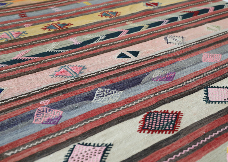 Vintage kilim rug in room decor setting, old rug, antique rug, pastel colors, faded colors, Turkish rug, vintage rug, soft rug, Portland, Oregon, rug store, rug shop, local shop,  antique kilim rug, bold colors, bright colors, faded colors