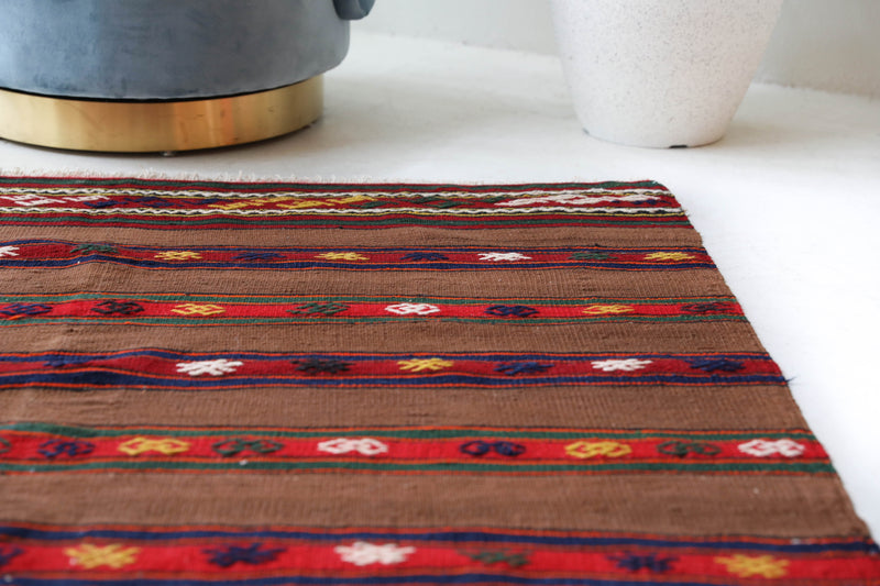 Vintage kilim rug in living room setting, bright colors, wild shaman, soft rug, bold color, Portland, Oregon, rug store, rug shop, local shop, vintage rug, modern kilim, warm colors