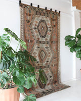 Vintage kilim rug in living room setting, old rug, antique rug, pastel colors, faded colors, Turkish rug, vintage rug, soft rug, Portland, Oregon, rug store, rug shop, local shop, earthy tones, earthy colors, warm colors