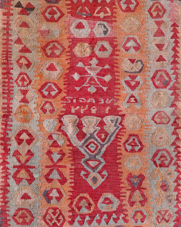 Vintage kilim rug in living room setting, old rug, antique rug, pastel colors, faded colors, Turkish rug, vintage rug, soft rug, Portland, Oregon, rug store, rug shop, local shop, earthy tones, earthy colors, warm colors