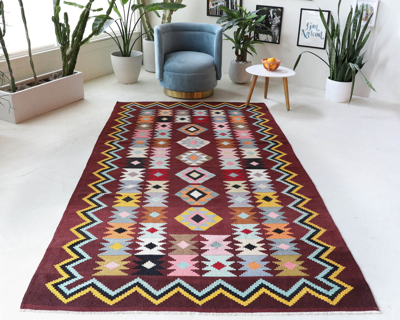 Vintage kilim rug in room decor setting, old rug, antique rug, pastel colors, faded colors, Turkish rug, vintage rug, soft rug, Portland, Oregon, rug store, rug shop, local shop, bold colors, bright colors, faded colors