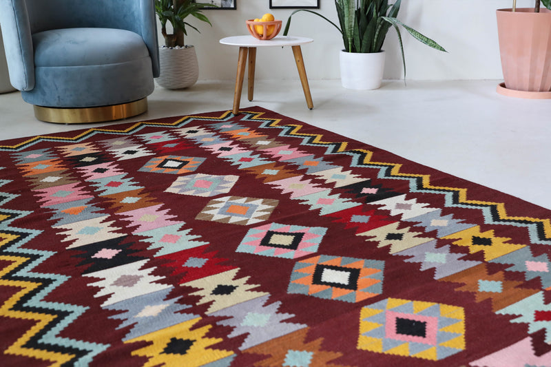 Vintage kilim rug in room decor setting, old rug, antique rug, pastel colors, faded colors, Turkish rug, vintage rug, soft rug, Portland, Oregon, rug store, rug shop, local shop, bold colors, bright colors, faded colors