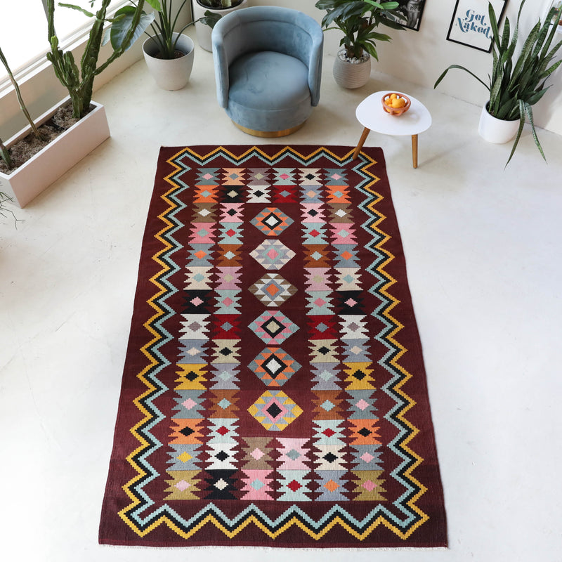 Vintage kilim rug in room decor setting, old rug, antique rug, pastel colors, faded colors, Turkish rug, vintage rug, soft rug, Portland, Oregon, rug store, rug shop, local shop, bold colors, bright colors, faded colors