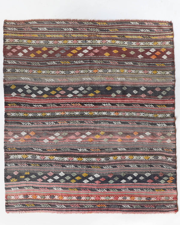 Vintage kilim rug in living room setting, old rug, antique rug, pastel colors, faded colors, Turkish rug, vintage rug, soft rug, Portland, Oregon, rug store, rug shop, local shop, earthy tones, earthy colors, warm colors