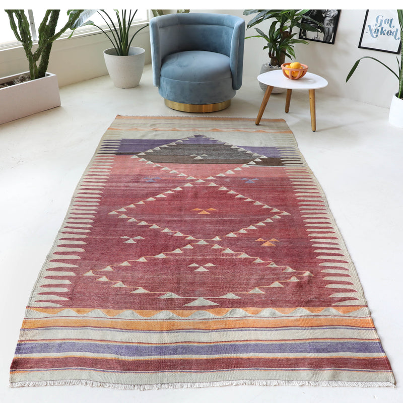 Vintage kilim rug in room decor setting, old rug, antique rug, pastel colors, faded colors, Turkish rug, vintage rug, soft rug, Portland, Oregon, rug store, rug shop, local shop, bold colors, bright colors, faded colors