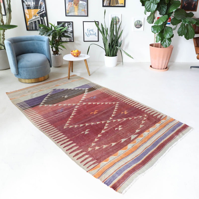 Vintage kilim rug in room decor setting, old rug, antique rug, pastel colors, faded colors, Turkish rug, vintage rug, soft rug, Portland, Oregon, rug store, rug shop, local shop, bold colors, bright colors, faded colors