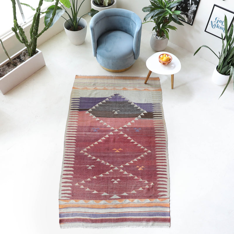 Vintage kilim rug in room decor setting, old rug, antique rug, pastel colors, faded colors, Turkish rug, vintage rug, soft rug, Portland, Oregon, rug store, rug shop, local shop, bold colors, bright colors, faded colors